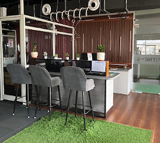 Front desk with grey bar stools on artificial grass