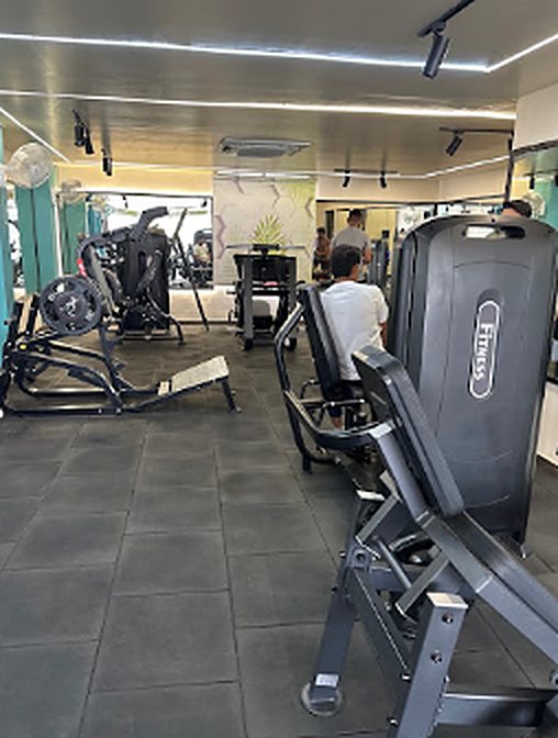 Selectorised machines and cardio area with white ceiling lights
